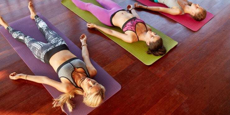 yoga class lying in corpse pose savasana