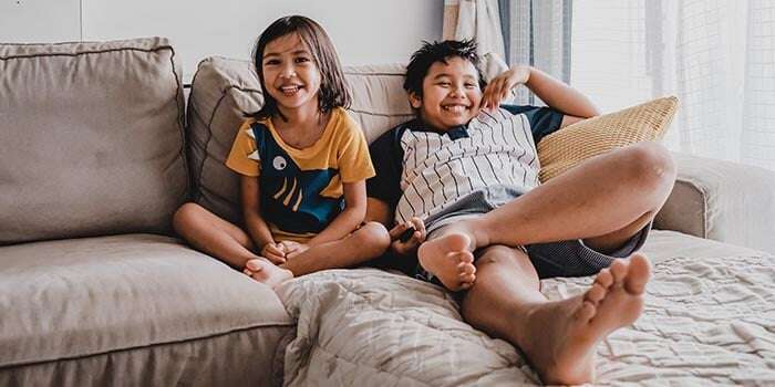 two children relaxing on the couch enjoying mindfulness for kids